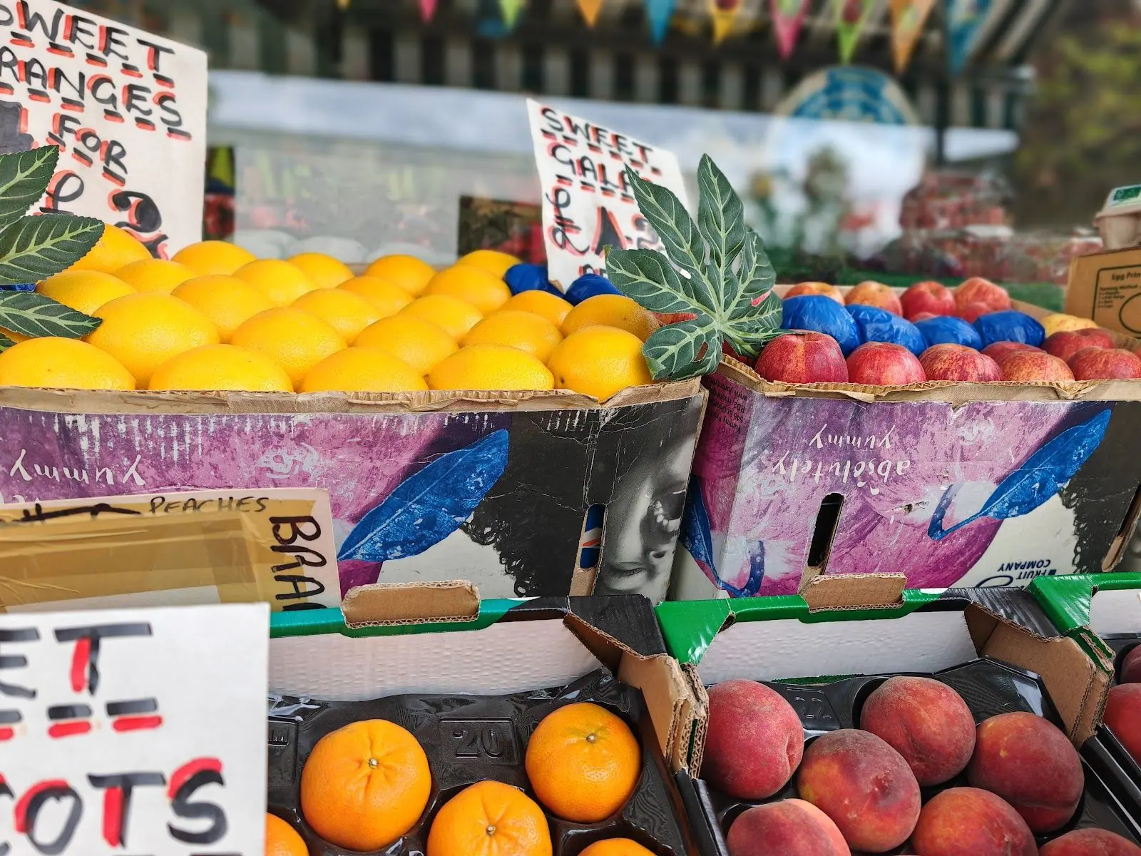 Oranges, peaches and plums on the display at Parade Fruiterers, West Ealing